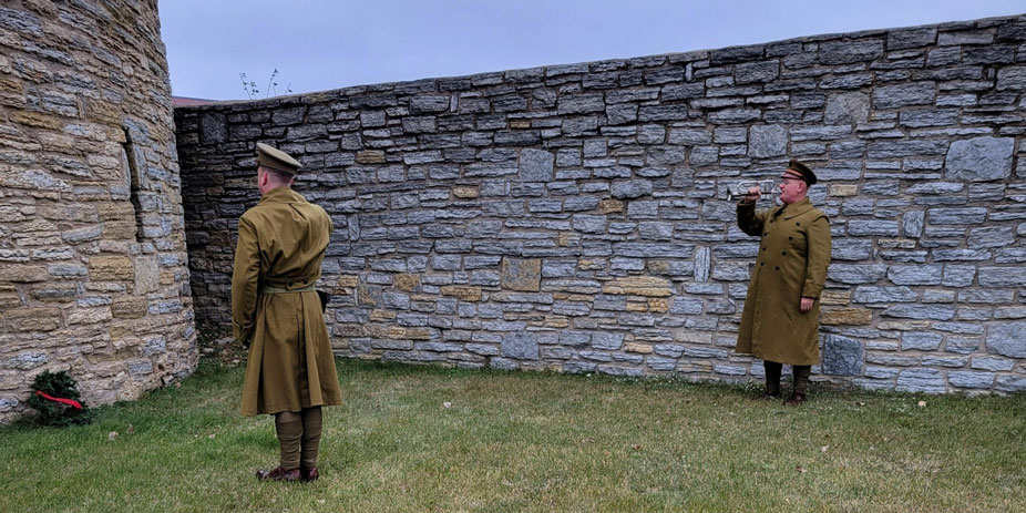 Staff in historical military uniform perform wreath ceremony at Ft. Snelling