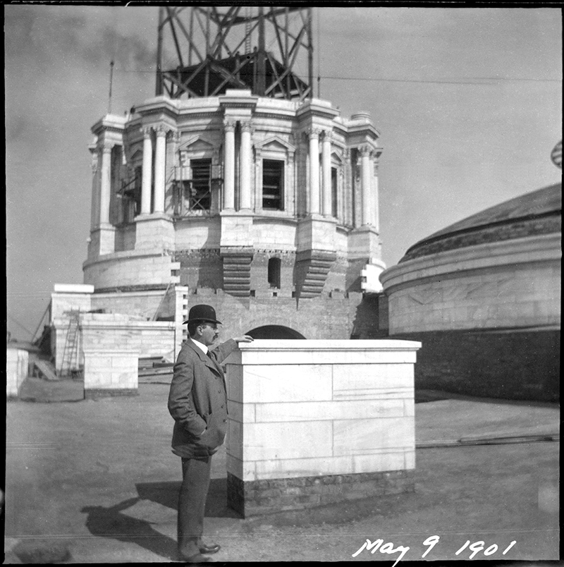 Capitol architect Cass Gilbert standing before the building’s partially completed dome, May 1901.