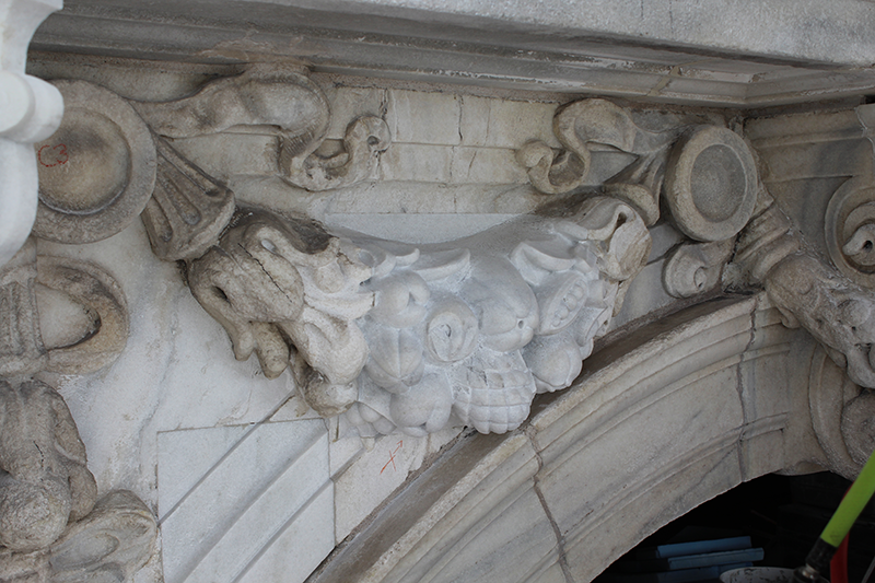 A newly carved, historically accurate festoon replacing deterioration. The new white Georgia marble was quarried from the same area as the original marble used in the 1905 building.