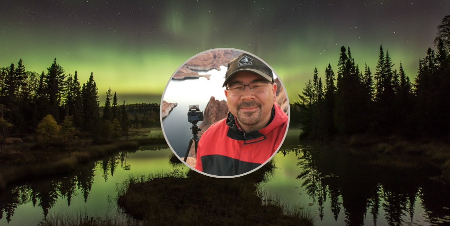 Image of photographer Travis Novitsky against a photograph of the northern lights.