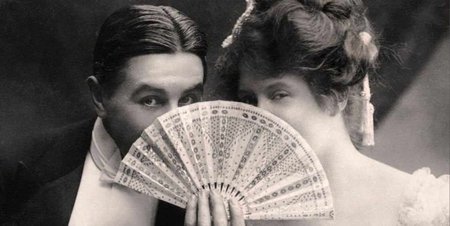 two Victorians flirting from behind a fan