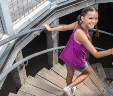 Young girl walking down stairs of the round tower