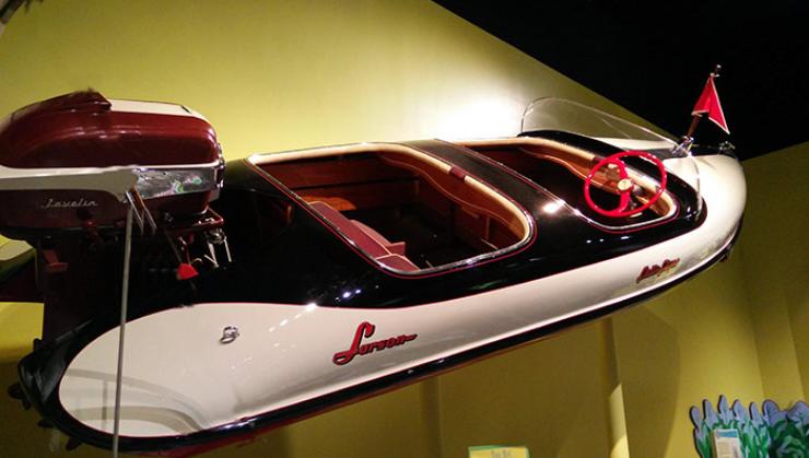 A 1956 model "Falls Flyer." A molded fiberglass boat with a twin cockpit and round hull.